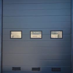 Sectional doors with plastic double-glazed windows and ventilation grilles