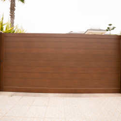 Sliding gates, with a gate made of sandwich panels